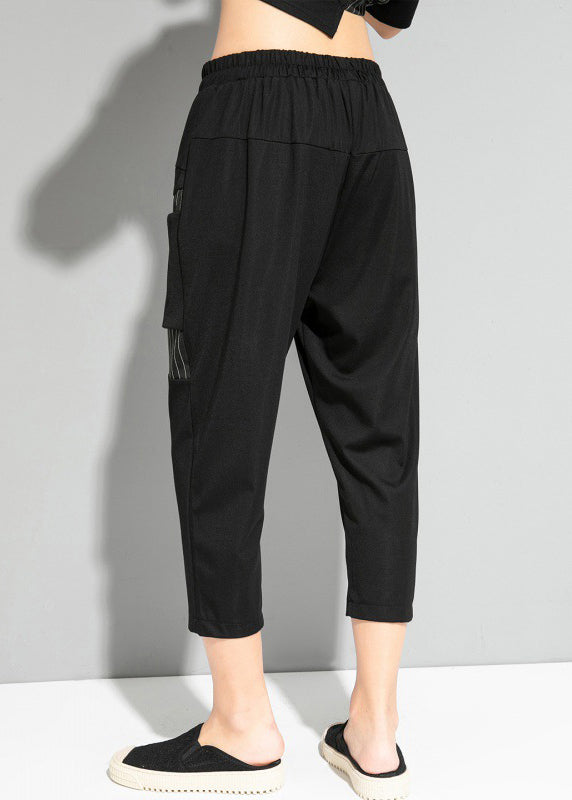 Feine schwarze gestreifte Patchwork-Taschen elastische Taillen-Crop-Hosen Sommer