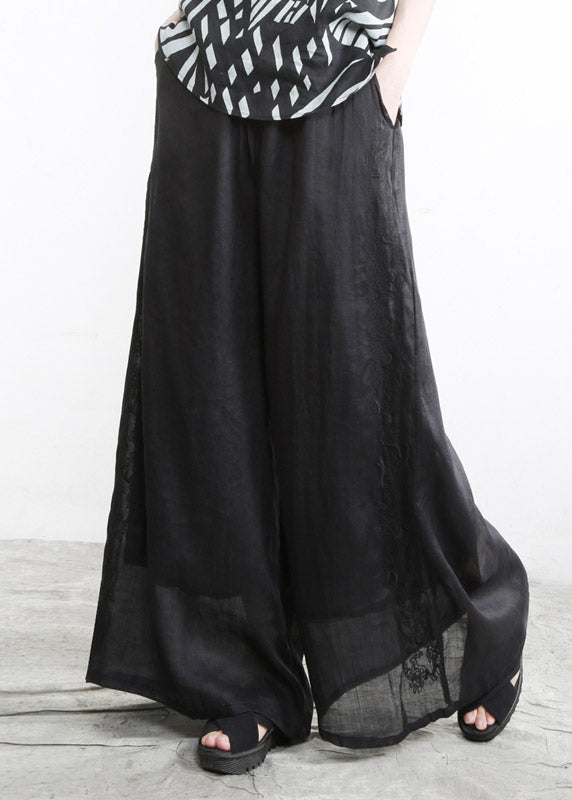 Moderne, schwarze Taschen, bestickte Blumen, elastische Taille, Leinenhose mit weitem Bein, Sommer