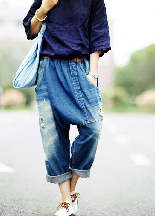 Frauen dunkelblaue asymmetrische Taschen elastische Taille zerrissene Jeans Frühling