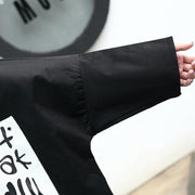 Mode schwarze Bluse aus Baumwollmischgewebe Locker sitzende Umlegekragen asymmetrische lässige Strickjacke 2018 Fledermausärmel Baggy-Baumwollmischoberteile